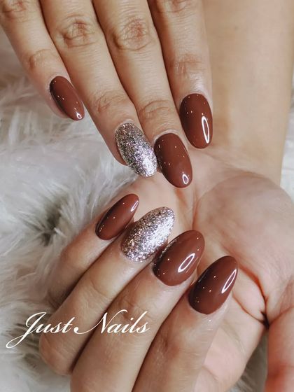 A full view of the chic brown and silver glitter nail set.
