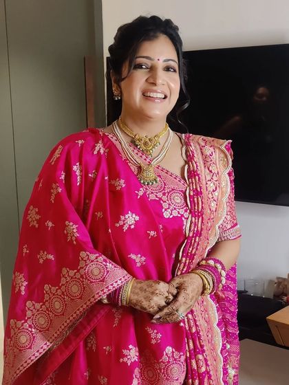 Gunjan's smile lights up the room. The makeup was designed to look fresh and radiant, perfect for a long day of wedding festivities.