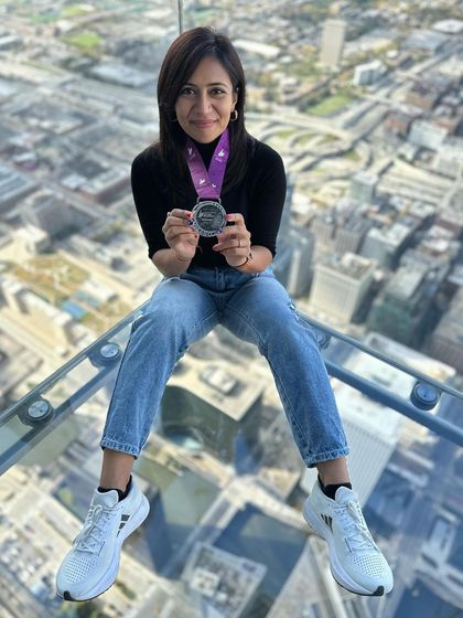 On top of the world, or at least on top of Chicago. Posing with my marathon medal on the glass floor of the Willis Tower. A celebration with a view.