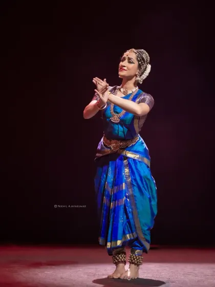 A moment of quiet contemplation during the performance. The contrast between dynamic movement and stillness is a key element of my recitals.