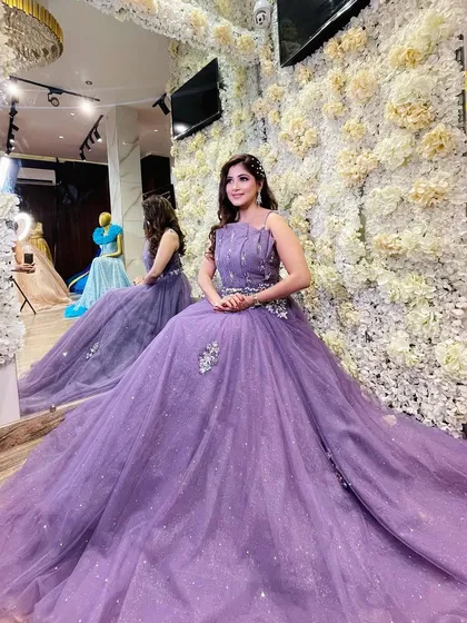 A client looking lovely in our lavender evening gown. The simple yet elegant design features a flowing tulle skirt with scattered sparkles and delicate silver embroidery on the bodice.
