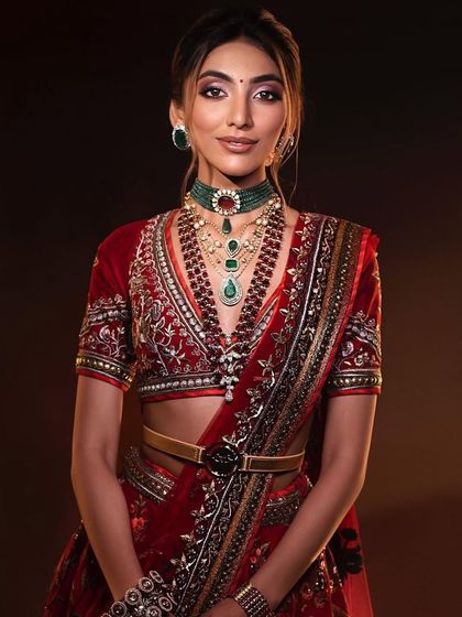 A smiling portrait of the classic red bride, capturing a moment of pure joy. The makeup is designed to last through all the emotions of the day.