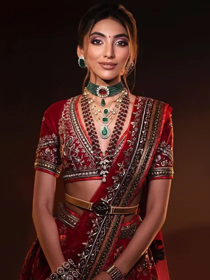 A smiling portrait of the classic red bride, capturing a moment of pure joy. The makeup is designed to last through all the emotions of the day.