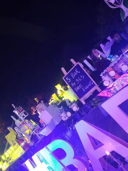A wide-angle view of the bustling LED bar at night. This perspective shows how the bright, colorful lighting makes the bar a central attraction, drawing guests in and energizing the party atmosphere.