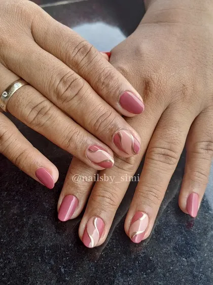 A chrome swirl design in pretty shades of pink. The metallic lines add a cool, modern touch.