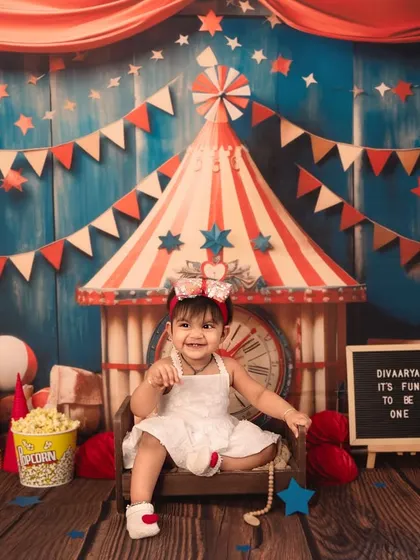 A happy smile from the star of the show. The letter board adds a personal touch, announcing that "It's Fun To Be One" in this colorful carnival theme.