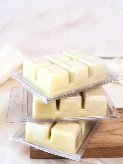 Melted soy wax, endless comfort. A stack of our wax melt clamshells, ready to fill your home with beautiful scents.