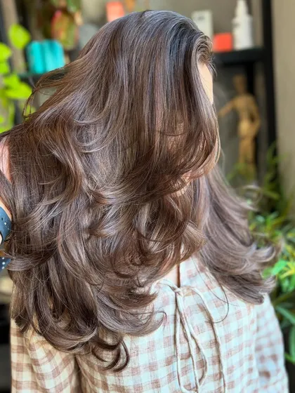 A close-up of the Frosted Hazelnut color, showing the movement and layers of the cut that complement the cool tones.