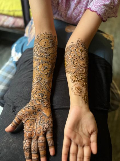 A view of both arms, one with a full design and the other with a simpler pattern.