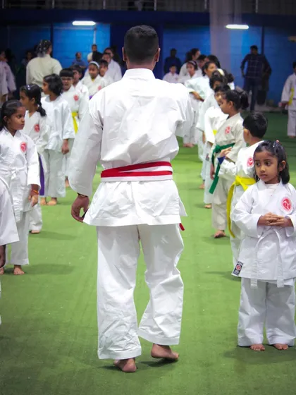 Even in a group setting, my focus is on individual form and discipline. Here, I am observing and guiding a class of young students, ensuring each one understands the fundamentals of their stance and movement.