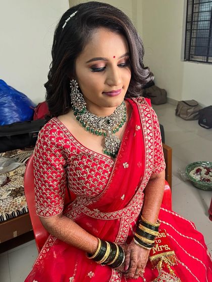 My gorgeous bride Sanjana ready for her reception in a classic red lehenga. We paired it with a soft smokey eye and a beautiful diamond and emerald necklace.