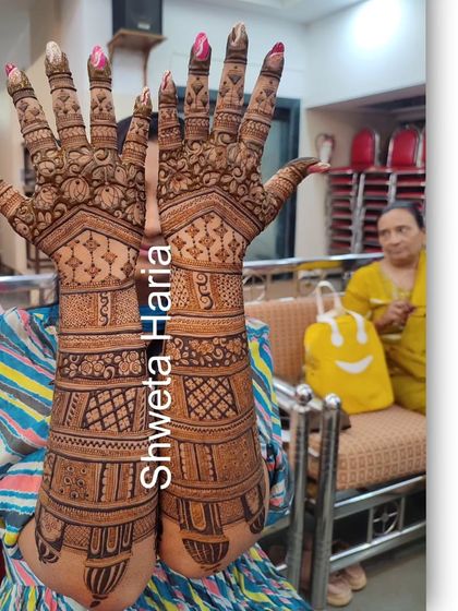 Another view of the groom's mom's mehendi, held up to show the full detail and coverage of the traditional design.