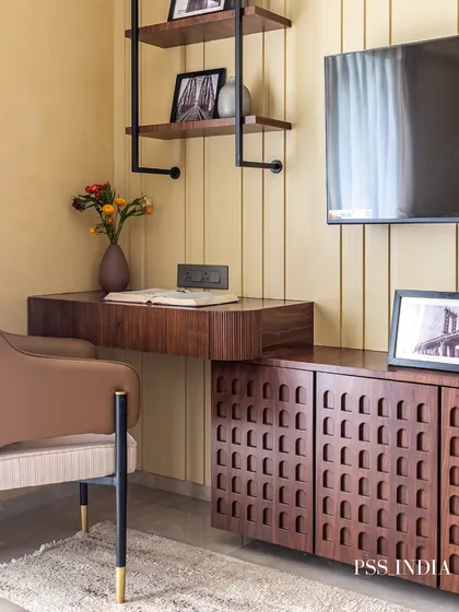 A full view of the bedroom and study area, showing how the warm wood tones and yellow paneled wall create a cohesive and inviting atmosphere throughout the space.
