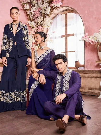 A full-length group shot showcasing a range of embroidered evening wear. My work involved creating a cohesive makeup direction for the entire campaign, from the men's natural look to the women's glamorous style.