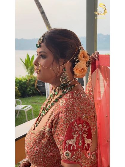 The bride's side view against the beautiful Goa backdrop, her hair perfectly styled.