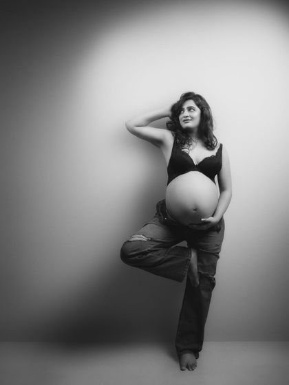 Capturing life's most precious moments. This breathtaking shot in jeans is a testament to the beauty and strength of a woman awaiting her little miracle.