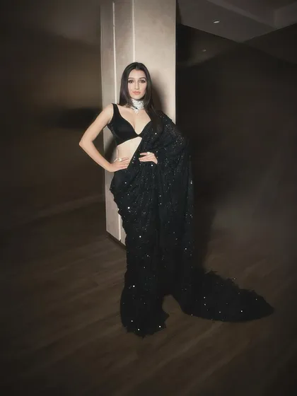 Saree draping isn't just for traditional events. This modern, chic look with a black sequin saree shows how a simple drape can be elevated for a cocktail party or a glamorous evening out.