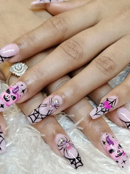 A complete look at our fun and spooky Halloween nail art. We can create custom designs for any holiday or occasion, showcasing detailed characters and patterns.