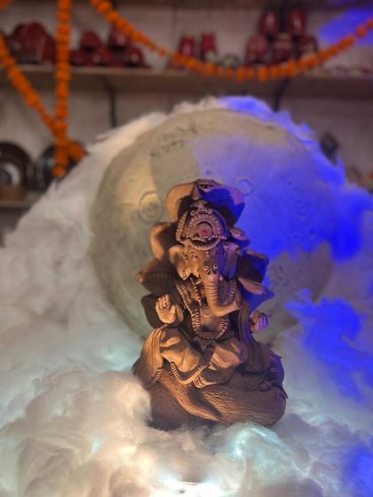 Another view of our studio's Ganesha idol, illuminated to create a divine atmosphere. The details are all handcrafted from clay.