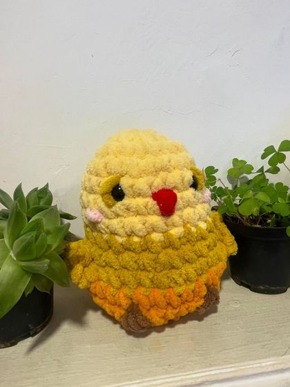 This is Bubba the Birdie, a super fluffy and squishy amigurumi toy. This yellow version is so bright and cheerful, perfect for adding a little sunshine to your day.