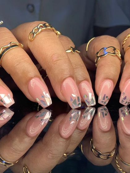 A chic and modern design with a sheer nude base and shattered silver foil pieces for a cool, edgy look.