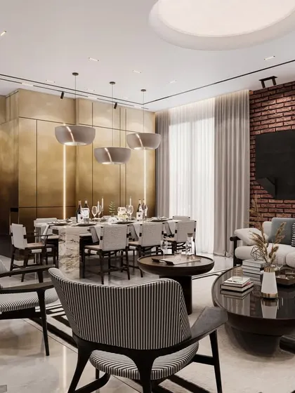 This view highlights the dramatic brass-paneled wall that defines the dining area. The design strikes a harmonious blend between simplicity and luxury, creating a calm and fashionable environment.