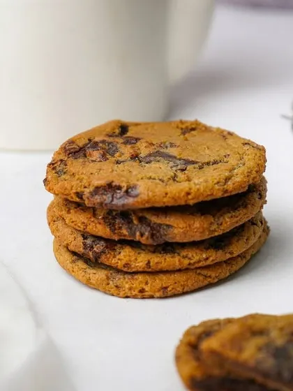 A stack of four chocolate chip cookies, shot in a bright, airy style. This classic presentation is perfect for websites, menus, and social media.