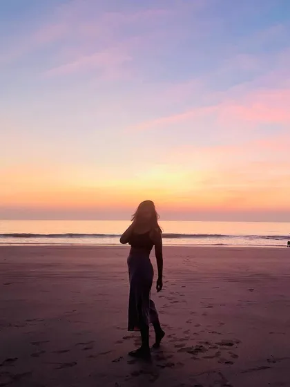 A silhouette against a beautiful sunset. This image captures a moment of quiet reflection, honoring the lessons of the past year and setting intentions for the future.