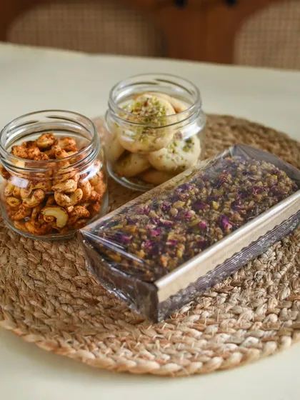 The contents of my Desi Delight Gift Basket, unboxed. You can see the fresh Baklava Tea Cake, Spicy Masala Cashews, and Almond Pista Cookies.