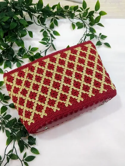 My signature diamond pattern clutch in a festive maroon and gold. This piece is a favourite for pairing with ethnic wear, and I take great care in getting every stitch just right. It's a timeless design that I love to create.