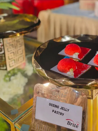 A platter of the Oozing Jelly Pastries, ready to be served from a stylish, modern dessert counter.