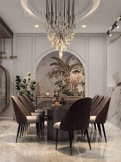 This shot highlights the open-concept design, where the dining area flows into a modern kitchen with a marble-clad island, perfect for entertaining.