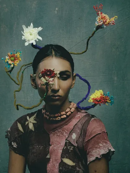 A look from the "Concrete Woes" series, which explores our relationship with nature. This avant-garde makeup uses floral elements to create a piece of living art.
