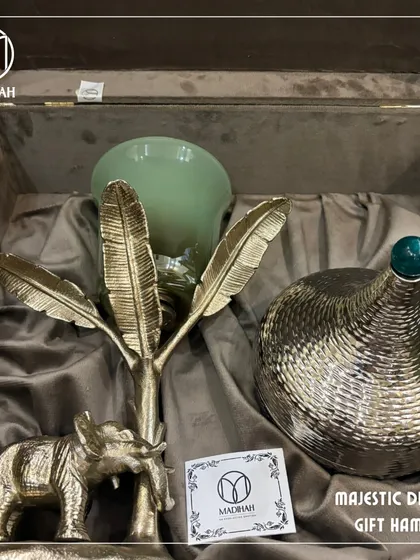 Another angle of the Majestic Diwali Hamper, showing the beautiful textures and materials. The combination of the glass hurricane, metal elephant, and lidded jar makes for a truly impressive gift.