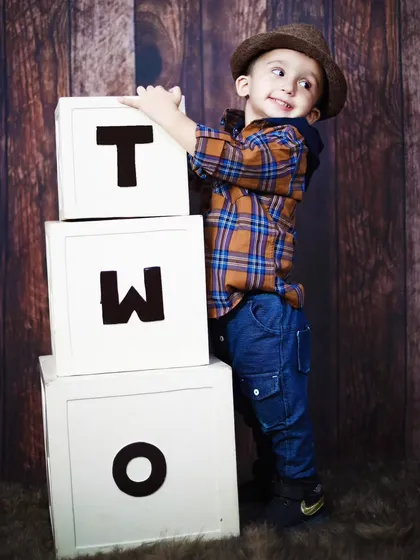 A playful and cheeky expression from a two-year-old boy during his birthday photoshoot.