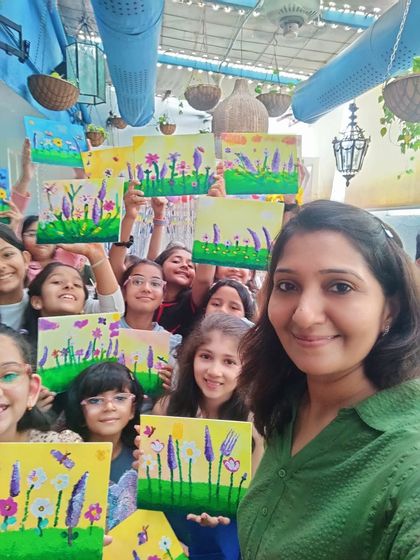 A group selfie capturing the smiles and colorful canvases from Nishka's 10th birthday art party.