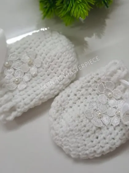 To keep tiny hands warm and prevent scratches, I make these matching white mittens. They feature the same delicate lace flower and pearl design as the booties.
