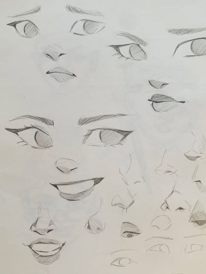 A collection of sketches practicing different facial features and expressions, a key exercise in our character design lessons.