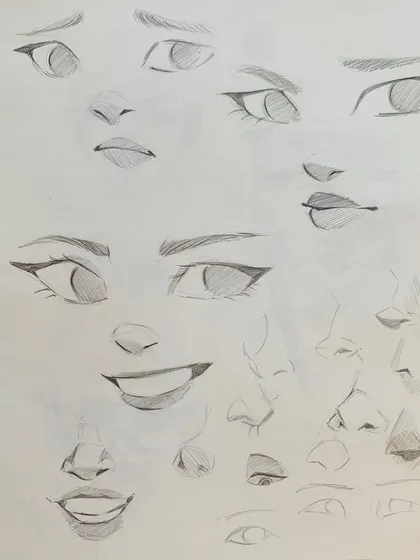 A collection of sketches practicing different facial features and expressions, a key exercise in our character design lessons.