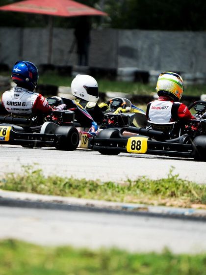 Three karts bunched together, fighting for position in the midfield.