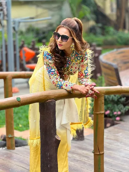 A confident pose on a bridge, showing off the unique and stylish outfit.