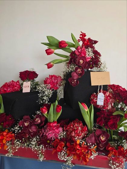 A wider view of the stunning red floral gift arrangement for Neetu Singh Kapoor, showing the scale and artistry of the composition.