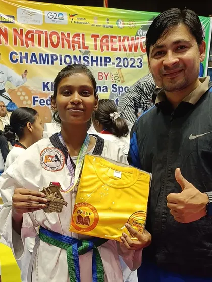 A student with her bronze medal and a prize t-shirt. Every achievement is celebrated.