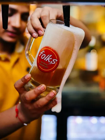 Capturing the perfect pour is all about timing and energy. This dynamic shot for Folks brewpub freezes the moment, showing the rich texture and head of the craft beer, making you feel like you're right there at the bar.