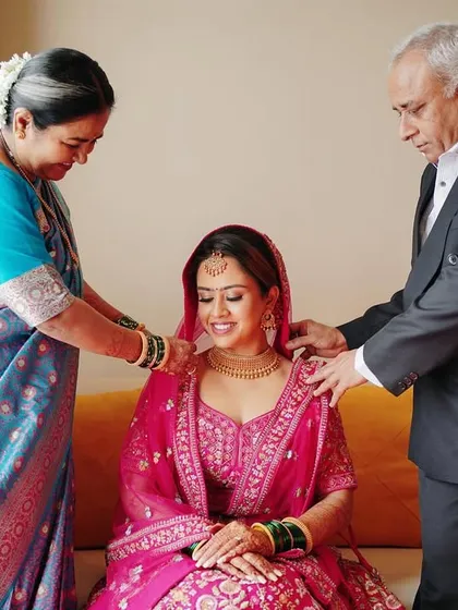 A touching moment of parents blessing their daughter on her wedding day. The pride and love in their eyes tell a beautiful story of family.