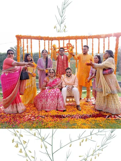 A lovely group photo of the couple with their family during the Haldi ceremony, set against a marigold backdrop.