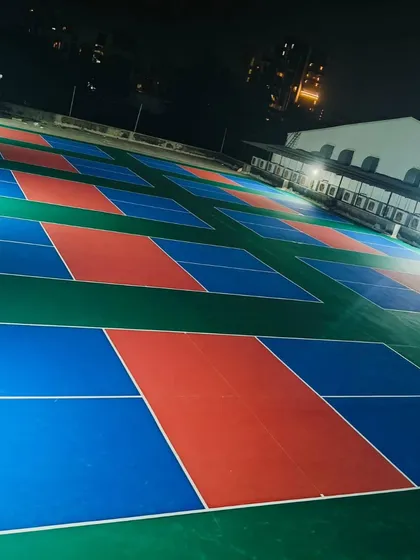 Our courts are fully lit and open 24/7 for those late-night matches or early morning practice sessions. This shot shows the arena after dark, highlighting the bright, even lighting across all playing surfaces.