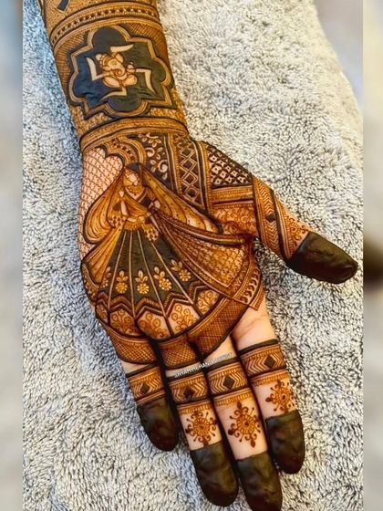 A beautiful design featuring a dancing woman on the palm, surrounded by traditional patterns.