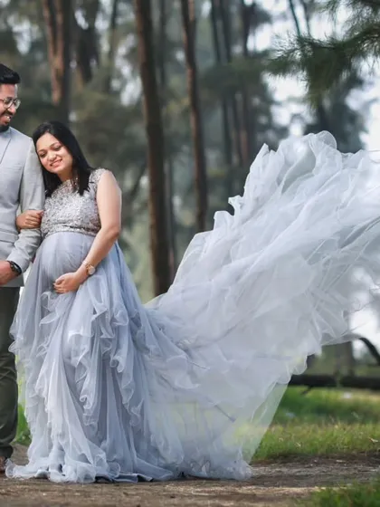Celebrate your journey together. This photo shows our popular grey embellished trail gown, perfect for couple photoshoots. We also offer coordinating blazers for dads-to-be to complete the look.