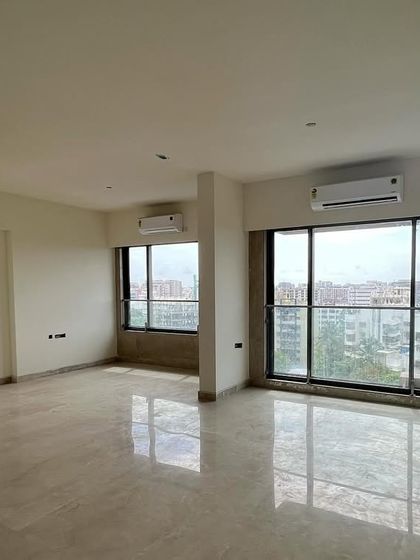 A "before" view of a living area, with bare floors and walls. This image contrasts with the final design, showcasing the dramatic transformation that is possible through thoughtful interior architecture and design.